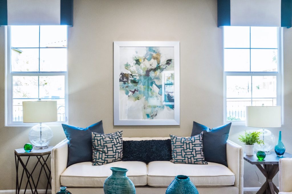 Upholstery DC white sofa in living room with blue throw pillows
